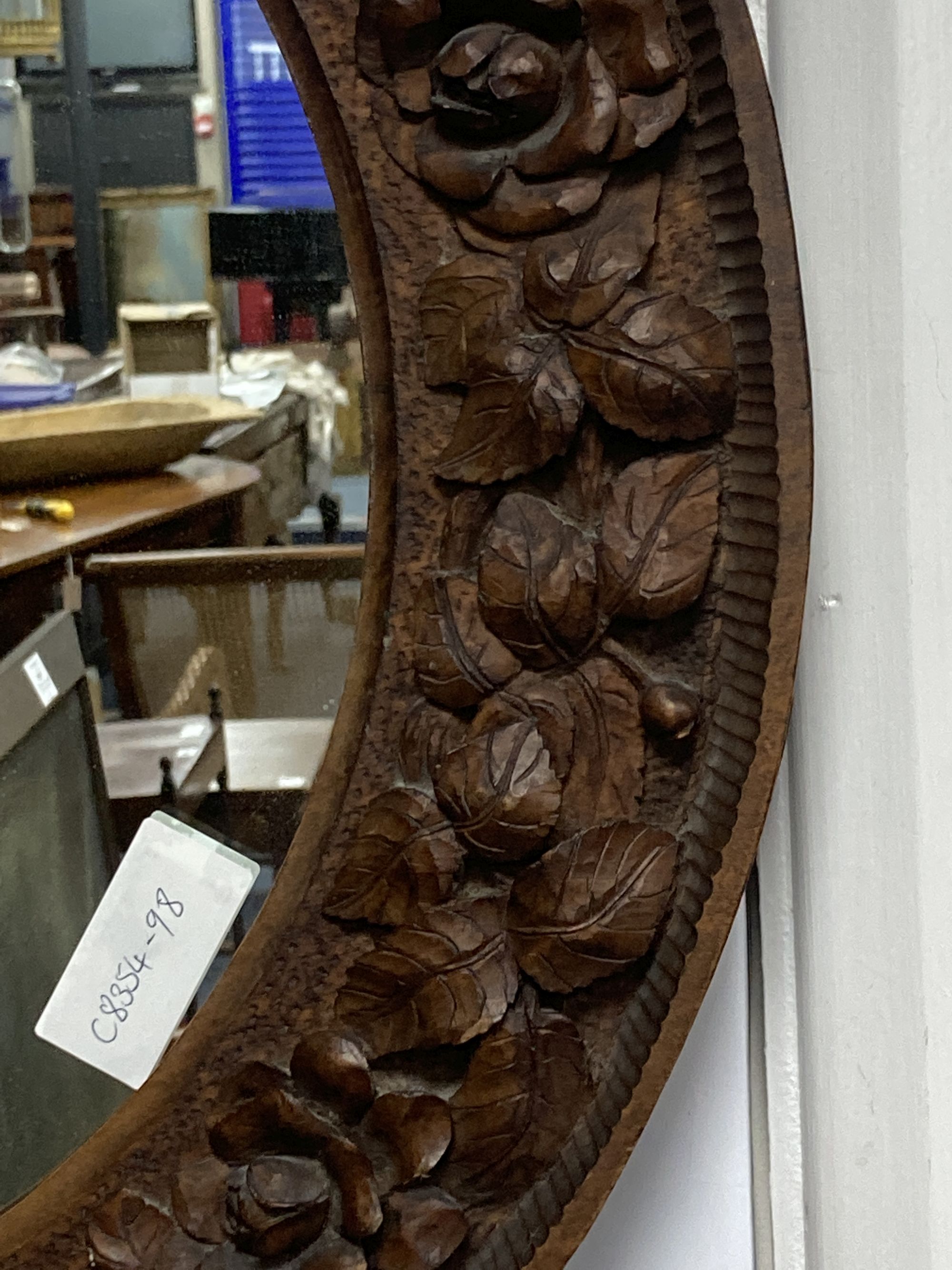 A carved wood circular wall mirror, diameter 56cm